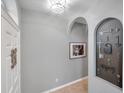 Bright entryway with decorative key art and neutral walls at 4506 Mapletree Loop, Wesley Chapel, FL 33544