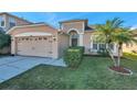 Attractive single-story home with a two-car garage and well-manicured lawn at 4506 Mapletree Loop, Wesley Chapel, FL 33544