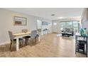 Dining area with white table, gray chairs, and hardwood floors at 4519 S Hesperides St, Tampa, FL 33611