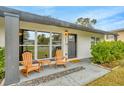 Inviting front porch with wooden rocking chairs and a stone pathway at 4519 S Hesperides St, Tampa, FL 33611