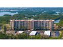 Aerial view of a waterfront condo building with parking and lush landscaping at 5400 Park N St # 209, St Petersburg, FL 33709