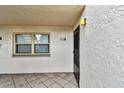 Building exterior showing entrance with a black door and window at 7701 Starkey Rd # 105, Seminole, FL 33777