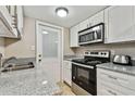 Kitchen with stainless steel appliances and granite countertops at 7701 Starkey Rd # 105, Seminole, FL 33777