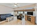 Living room with blue sofa, armchair, and a fireplace at 7701 Starkey Rd # 105, Seminole, FL 33777