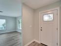 Bright entryway with a white door and wood-look flooring at 1004 Peninsula Ave, Tarpon Springs, FL 34689