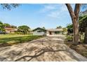 Newly renovated home with a large driveway and landscaped lawn at 1004 Peninsula Ave, Tarpon Springs, FL 34689