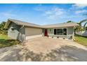 Newly renovated home with a two-car garage and manicured landscaping at 1004 Peninsula Ave, Tarpon Springs, FL 34689