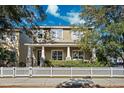 Two-story house with front porch, stone accents, and white picket fence at 10515 Fenceline Rd, New Port Richey, FL 34655