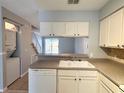 Kitchen with white cabinets, granite countertops and a breakfast bar at 11356 Stratton Park Dr, Temple Terrace, FL 33617