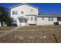 Tan two-story house with multiple windows and a landscaped yard at 1434 Cleveland St # 4, Clearwater, FL 33755