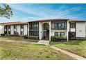 Front view of a two-story condo building with balconies at 1882 Pine Ridge W Way # E1, Palm Harbor, FL 34684