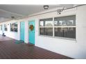 Building hallway with teal door and tile flooring at 1950 59Th N Ave # 110, St Petersburg, FL 33714