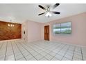 Bright living room with tile floors and ceiling fan at 2 N Fernwood Ave # 16, Clearwater, FL 33765