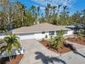 An aerial view showcasing a charming house with a well-manicured lawn at 2004 Virginia Dr, Bradenton, FL 34205