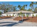 Newly renovated home exterior, showcasing a landscaped front yard and walkway at 2004 Virginia Dr, Bradenton, FL 34205