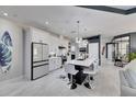 Modern kitchen with white cabinets, island, and stainless steel appliances at 204 Latitude Pl, Apollo Beach, FL 33572