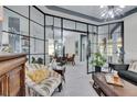 Bright living room with glass partition and stylish furniture at 204 Latitude Pl, Apollo Beach, FL 33572