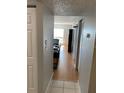 View down hallway with light wood floors and doors to other rooms at 2625 State Road 590 # 532, Clearwater, FL 33759