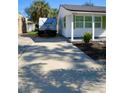 Long driveway leading to a charming white house at 2660 Miriam S St, Gulfport, FL 33711