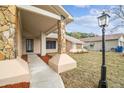 Attractive front entry with stone columns and a walkway at 2715 Narcissus Dr, Holiday, FL 34691