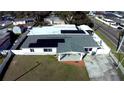 Single-story home with a large yard and solar panels on the roof at 2801 Auburn W Ave, Tampa, FL 33614