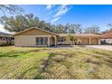 Ranch style home with a spacious lawn and attached three car garage at 3245 Canal Pl, Land O Lakes, FL 34639