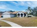 House with a two-car garage and large front yard at 4209 Amber Ridge Ln, Valrico, FL 33594