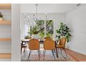 Bright dining room with large window and modern chandelier at 4320 Middle Lake Dr, Tampa, FL 33624