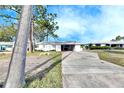 White single story home with driveway and mature trees at 4730 Shore Acres Ne Blvd, St Petersburg, FL 33703