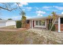 Brick house with red door and a landscaped yard at 5290 38Th S Way, St Petersburg, FL 33711