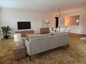 Living room with staged furniture and carpeting, view of dining area at 6623 16Th N St, St Petersburg, FL 33704