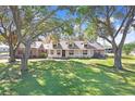 Charming home nestled amongst mature trees on a spacious lot at 6819 Stafford Rd, Plant City, FL 33565