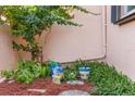 Private patio garden with lush greenery and gardening supplies at 7262 55Th N Ave, St Petersburg, FL 33709