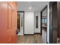 Condo entryway with terracotta door and dark wood accents at 7466 Bayshore Dr # 406, Treasure Island, FL 33706