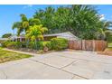 Brick home with fenced yard, mature trees, and a large patio at 8296 15Th N Way, St Petersburg, FL 33702