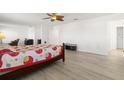 Spacious bedroom with wood-look floors and ceiling fan at 8919 N River Rd, Tampa, FL 33635