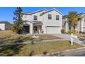 Two-story house with a large driveway and landscaping at 8919 N River Rd, Tampa, FL 33635