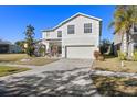 Two-story house with a large driveway and landscaping at 8919 N River Rd, Tampa, FL 33635