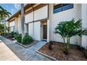 Condo building exterior showcasing manicured landscaping and multiple unit entrances at 9209 Seminole Blvd # 138, Seminole, FL 33772