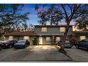 Evening view of two-story townhome with parking at 10061 Lake Oak Cir, Tampa, FL 33624