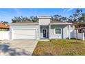 Newly built gray house with white garage door at 1103 S Prospect Ave, Clearwater, FL 33756