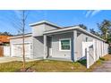 Side view of gray house, white fence, and tree at 1103 S Prospect Ave, Clearwater, FL 33756