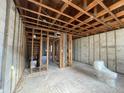 Unfinished bedroom with exposed framing and a toilet at 1151 Rue Des Chateaux, St Petersburg, FL 33707