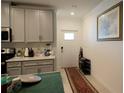 Kitchen entryway with white door and rug at 16843 Forge Surf St, Land O Lakes, FL 34638