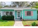 Adorable teal house with white door and pink accents at 2600 46Th S St, Gulfport, FL 33711