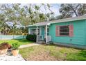 Light teal house with walkway, landscaping, and white fence at 2600 46Th S St, Gulfport, FL 33711