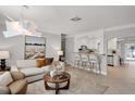 Bright living room with modern decor and an open layout to the kitchen at 2740 E Vina Del Mar Blvd, St Pete Beach, FL 33706