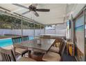 Screened patio with hot tub, dining table, and view of the refreshing pool at 306 Scott Ct, Palm Harbor, FL 34684