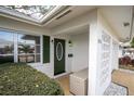 Inviting front entrance with green door and a decorative block wall at 4526 101St N Ave, Pinellas Park, FL 33782