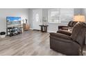 Living room with gray walls, laminate floors and brown recliner chairs at 4526 101St N Ave, Pinellas Park, FL 33782